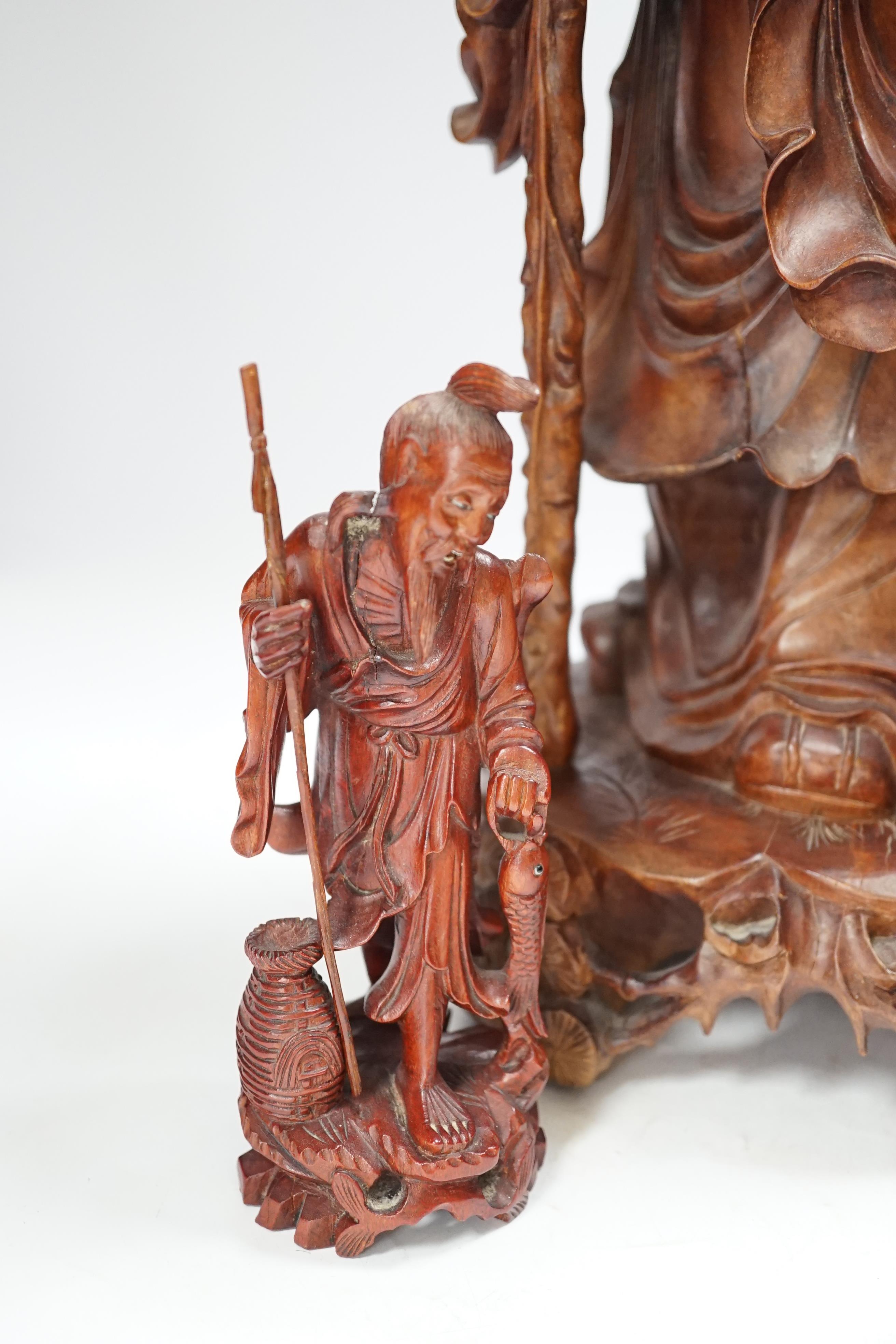 A large Chinese carved wooden figure group of Shou Lao and a pair of small carved figures, figure group 52cm high